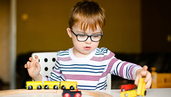 child playing with toy train